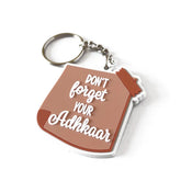 Bruine en witte sleutelhanger met forget your adhkaar tekst ontwerp voor je adhkaar