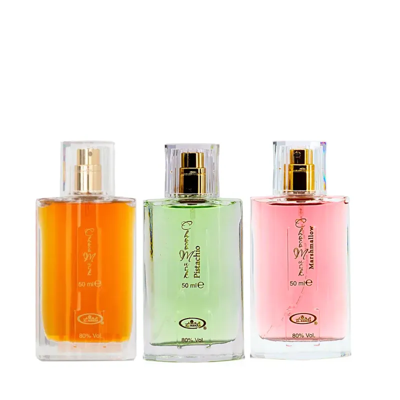 Drie parfumflessen met goudspray en doorzichtige doppen in oranje, groen en roze voor Choco Musk, Pistachio Musk en Marshmallow Musk