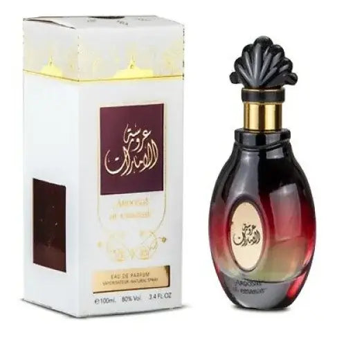 Donkere rode en zwarte glazen parfumfles van ard al zaafaran aroosat al emarat met gouden decoratieve dop en arabische kalligrafie