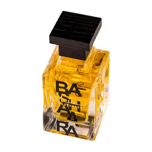 Een transparante vierkante glazen fles gevuld met gouden gele vloeistof en een zwarte dop met bath & body works tekst