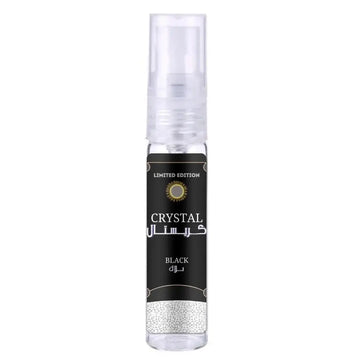 A sleek transparent spray bottle of ard al zaafaran crystal black with a black label and gold accents in english and arabic