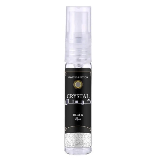 A sleek transparent spray bottle of ard al zaafaran crystal black with a black label and gold accents in english and arabic
