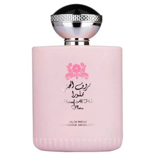 Roze rechthoekige parfumfles met zwarte en zilveren dop met arabische tekst en merknaam flora van ard al zaafaran huroof al hub flora