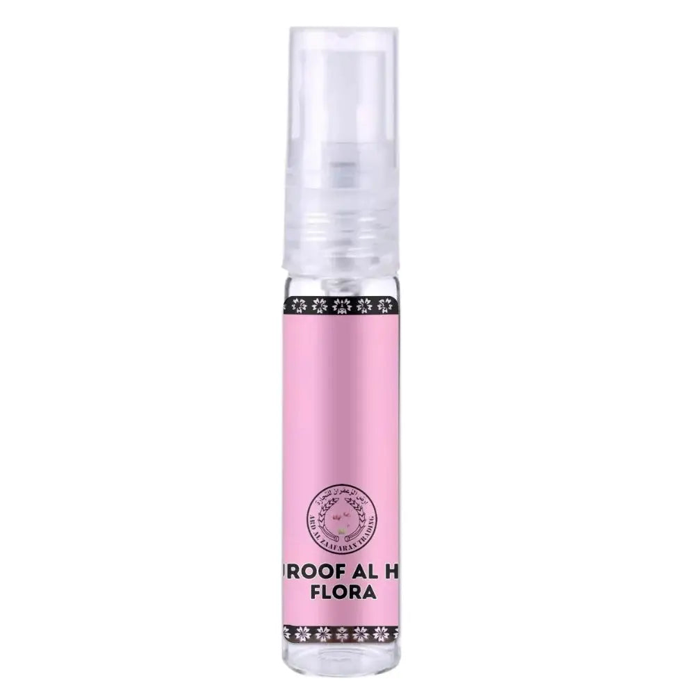 Roze cilindervormige parfumbottle met transparante spray en zwarte decoratieve bloemmotieven van ard al zaafaran huroof al hub flora