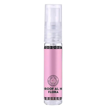 Roze cilindervormige parfumbottle met transparante spray en zwarte decoratieve bloemmotieven van ard al zaafaran huroof al hub flora