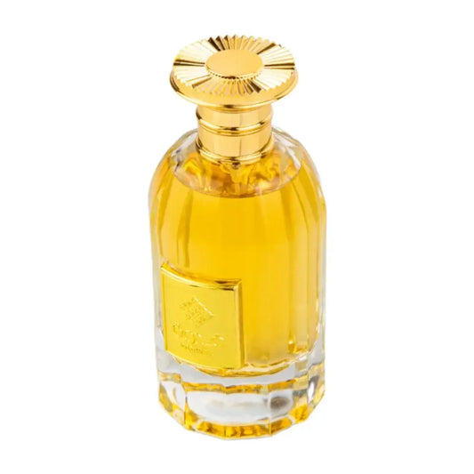 Golden-hued ard al zaafaran qidwah perfume bottle with faceted crystal body and ornate sunburst gold cap