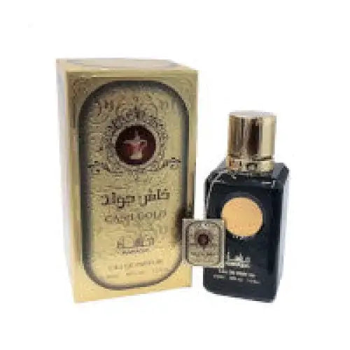 Black glass bottle with gold cap and amber label next to ornate golden box cash gold unisex 100ml edp manasik