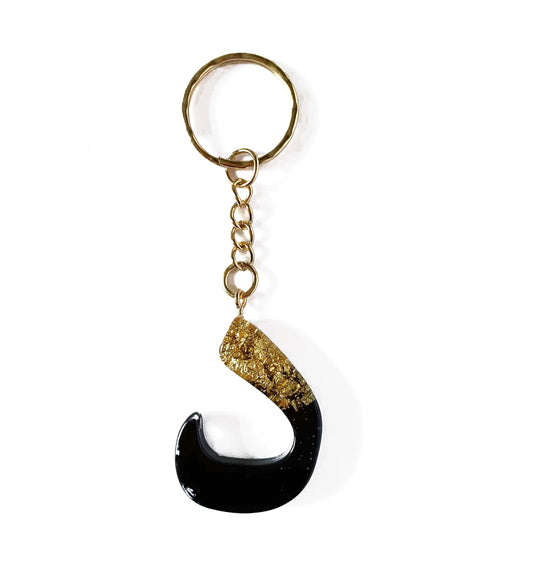 Dal arabisch alfabet sleutelhanger zwart goud resin s-vorm met glanzende afwerking en metallic vlokken