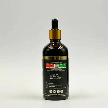 Donkere amberkleurige glazen druppelfles met goudkleurige dop en zwart label van ethiopische black seed olie koud geperst 100ml