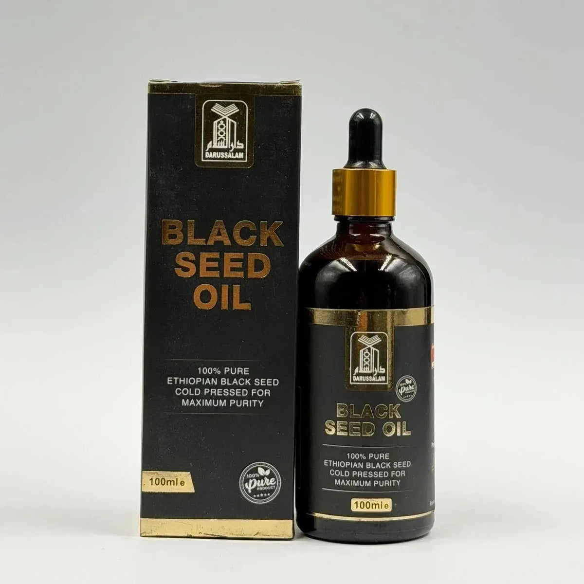 Ethopische black seed olie koud geperst in een donker amber glasfles met goudkleurige druppelaar en zwarte verpakking