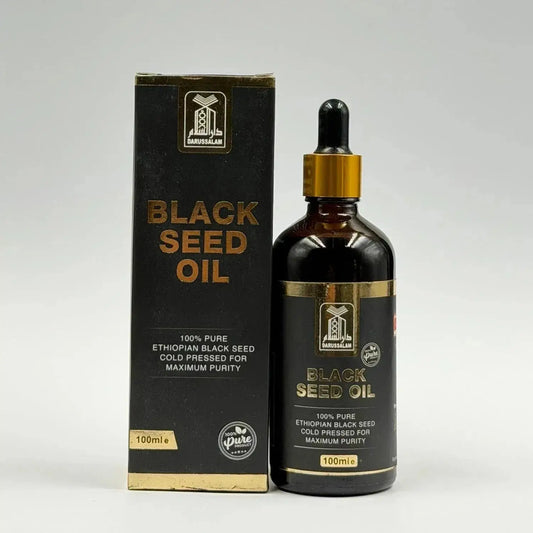 Ethopische black seed olie koud geperst in een donker amber glasfles met goudkleurige druppelaar en zwarte verpakking