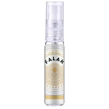 Een heldere glazen sprayfles met een transparante dop en een sierlijk wit gouden etiket met de naam falak 100 ml