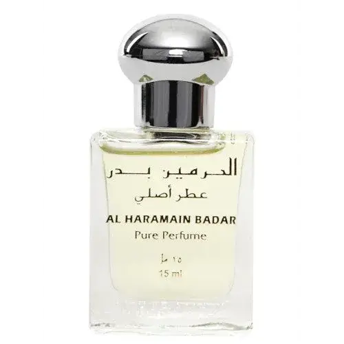 Een duidelijke glazen fles al haramain badar pure parfumolie met zilveren dop en arabisch label