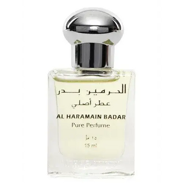 Een duidelijke glazen fles al haramain badar pure parfumolie met zilveren dop en arabisch label