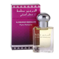 Een heldere glazen fles al haramain mukhallath pure parfumolie met zilveren dop en gouden vloeistof naast paarse doos