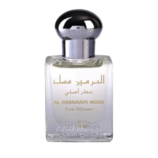 Een heldere glazen fles van al haramain parfumolie musk met een zilveren dop en gouden letters op de voorkant
