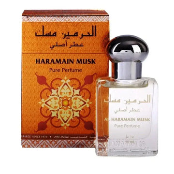 Een heldere glazen fles al haramain parfumolie musk met zilveren dop en goudkleurig arabisch opschrift