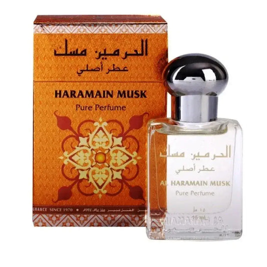 Een heldere glazen fles al haramain parfumolie musk met zilveren dop en goudkleurig arabisch opschrift