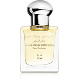 Een glanzende transparante glazen fles al haramain white oud pure parfumolie met zilveren dop en goudgele vloeistof