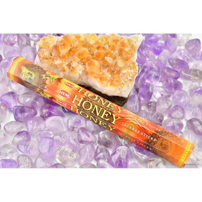 Honey-scented incense sticks next to a piece of honeycomb from Hem Honey – Incense