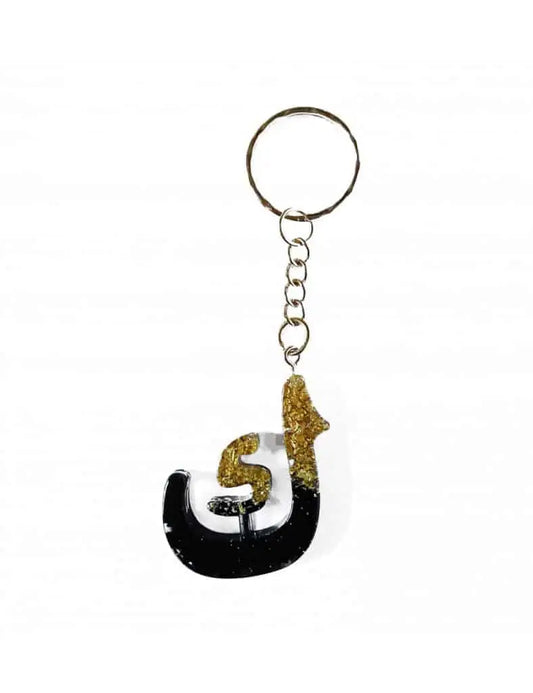 Kaaf arabisch alfabet sleutelhanger van zwarte en gouden glitter hars met gestileerde arabische letter design