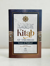 Een marineblauw en bruin hardbackboek met goudembossing arabisch schrift getiteld kitab at-tawheed door imam al-bukhari
