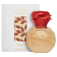 Gouden roosvormige Lattafa La’hdath Pride parfumfles met rode accenten