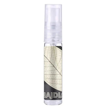 Heldere glazen sprayfles met transparante dop en beige bladontwerp op etiket voor Lattafa Parfum Najdia