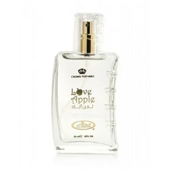 Clear glass bottle of crown perfumes love apple fragrance with a gold-tone spray nozzle and embossed arabic script on the label