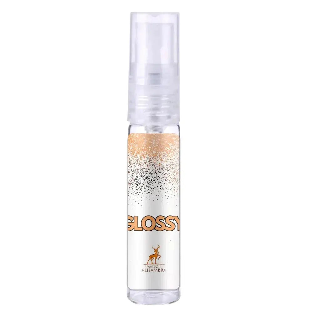 Heldere glazen sprayfles met gouden en zilveren glitters en oranje glossy label van maison alhambra