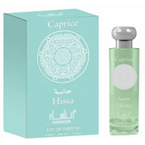 Manasik hissa caprice eau de parfum in een helder glazen fles met zilveren dop en lichtgroene vloeistof naast mintgroene doos met wit ontwerp