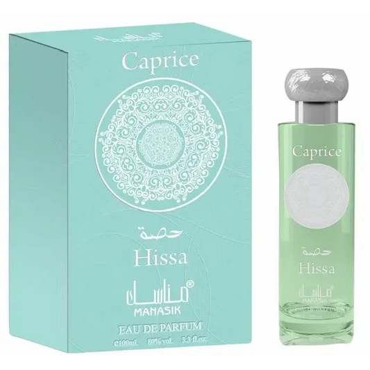 Manasik hissa caprice eau de parfum in een helder glazen fles met zilveren dop en lichtgroene vloeistof naast mintgroene doos met wit ontwerp