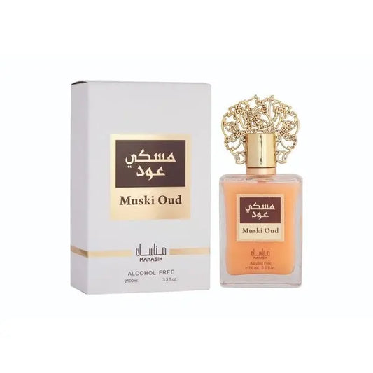 Een glazen fles muski oud alcoholvrije parfum van Mahasik met een gouden filigraan dop en amberkleurige vloeistof
