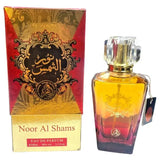Gouden en rode gradient glazen parfumfles met facet geslepen kristallen dop labeled noor al shams eau de parfum