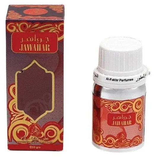 Een kleine heldere glazen fles met witte schroefdop en sierlijke rode en gouden etiketten van jawahir van al-fakhr perfumes