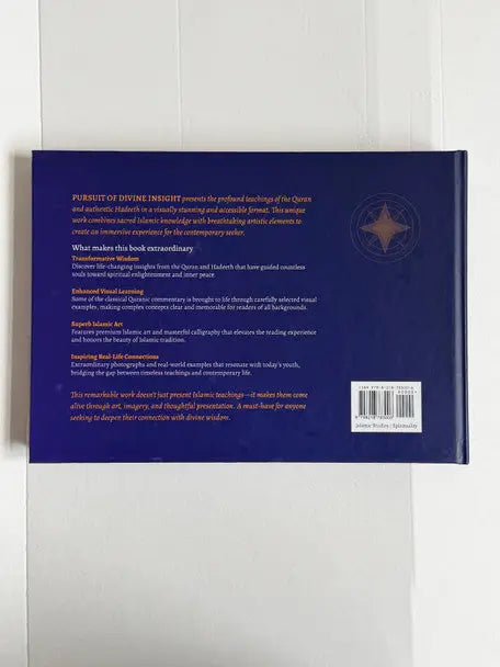 Deep blue hardcover book pursuit of divine insight with gold foil text and compass rose emblem on the back cover