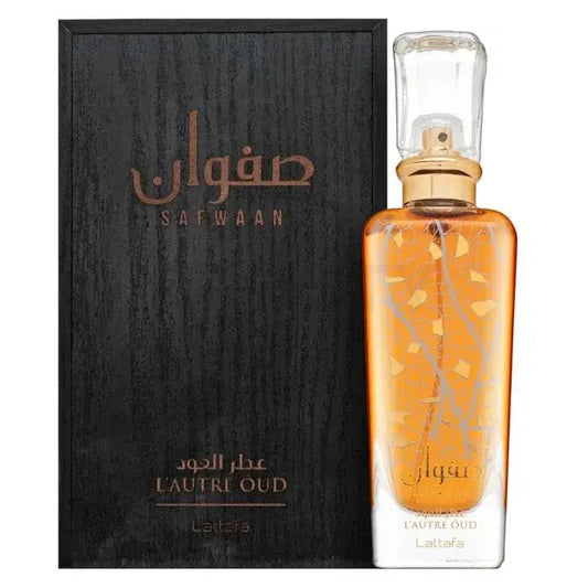 Een gouden rechthoekige glazen parfumfles safwaan l’autre oud met matte gouden dop en geëtst boomtakontwerp