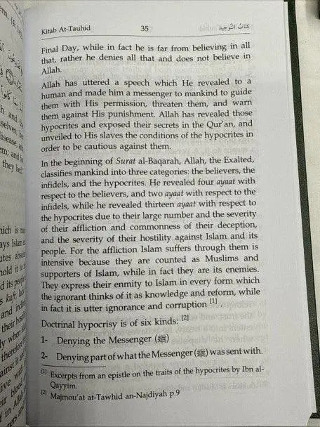Open book the book of tawheed with black arabic script and english translation on white pages from kitab al-tawhid